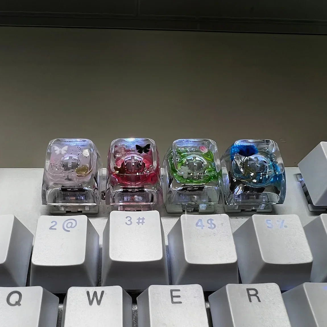 Nature's Bloom Butterfly Transparent Keycaps showcasing delicate nature's bloom designs embedded in crystal-clear resin, a vibrant and unique keyboard accent.