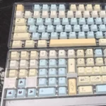 Close-up of Charming C Fox PBT dye-sub keycaps set, showcasing vibrant anime-inspired art from multiple angles. High-quality, durable PBT with playful design.