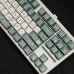 Vibrant Camellia PBT keycaps set with exquisite dye-sublimated floral art, emphasizing durability and elegant design for personalized keyboards.