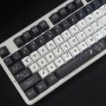 Elegant Black Camellia V3 PBT keycaps set, 139-key set, featuring exquisite dye-sublimated art for sophisticated keyboard personalization.