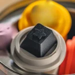 Close-up of a premium Celestial Aluminum R4 accent keycap, showcasing its CNC precision and ethereal starry night design from various angles.