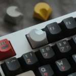 A Celestial Moon Artisan Keycaps, hand-polished CNC aluminum with a sleek, glossy white finish and ergonomic contours, evoking setup.