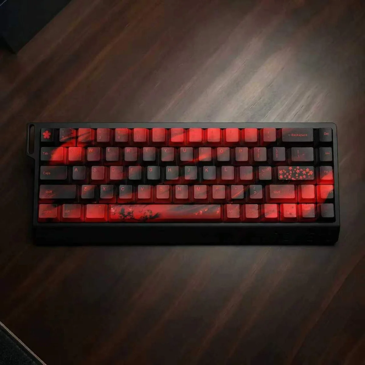 "Elegant black and red cherry blossom PBT dye-sub keycap set displayed from a unique angle, highlighting the crisp legends and premium feel."