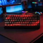 "Elegant black and red Cherry Blossom PBT dye-sub keycap set. Close-up view reveals premium floral design and crisp legends from a unique angle."