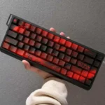"An angled view of the premium PBT dye-sub Cherry Blossom keycaps, featuring the elegant black and red motif and crisp legends. Ideal for artistic cus