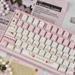 Playful Cherry Cake PBT Keycaps Set in pastel pinks, featuring sweet cherry and cake designs from all angles. Durable PBT for a charming desk.