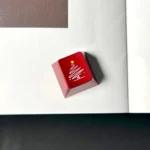 A close-up view of the premium CNC aluminum Christmas tree keycap, showcasing its intricate metallic design and festive snowflake details from multiple angles.