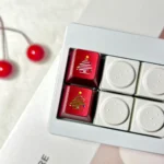 A close-up of a premium CNC aluminum Christmas tree keycap, showcasing intricate metallic details and delicate snowflakes for a festive keyboard.