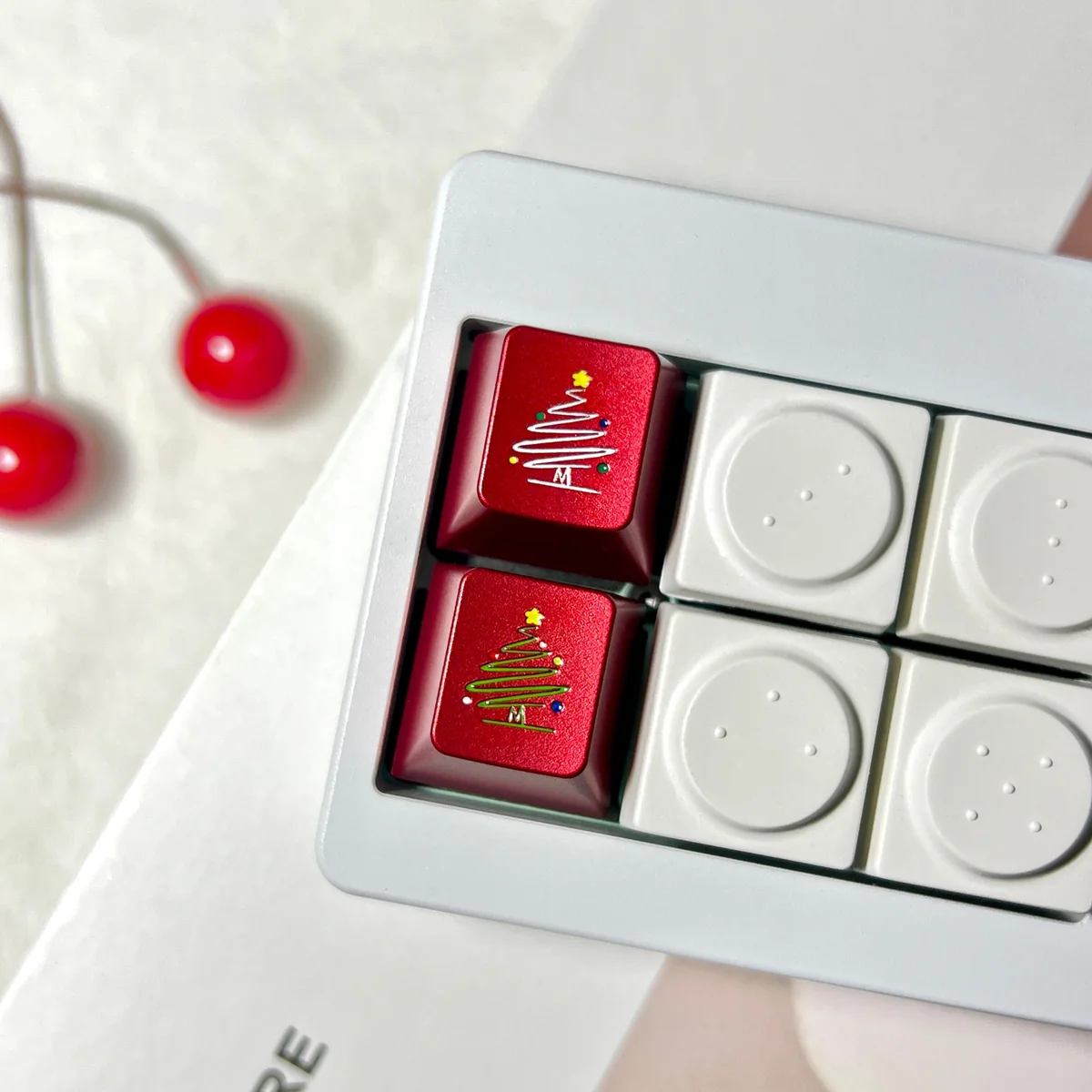 A close-up of a premium CNC aluminum Christmas tree keycap, showcasing intricate metallic details and delicate snowflakes for a festive keyboard.