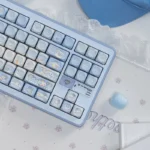 Multiple angles of the whimsical Dreamy Cinnamoroll Cloud PBT MOA Keycap Set, showcasing its pastel colors and serene cloud motifs for a playful desktop.