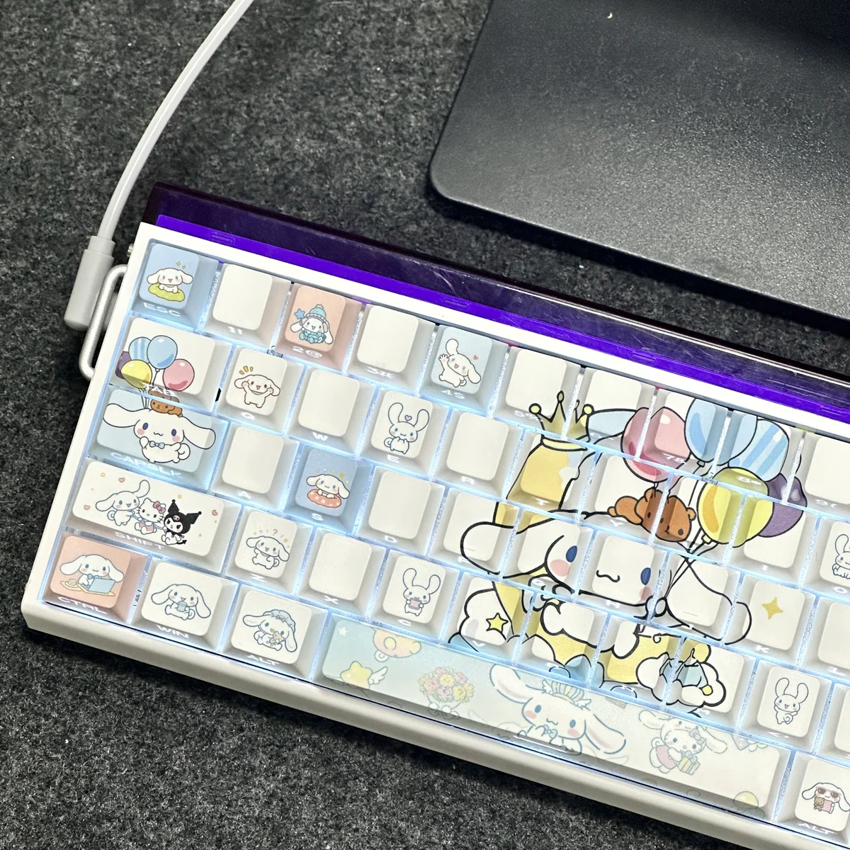 Close-up of adorable Cinnamoroll side-lit PBT keycaps set, showcasing sweet character art and luminous legends for a charming, playful keyboard aesthetic.