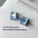 Premium CNC aluminum ethereal cloud artisan keycap, captured from a unique angle, revealing its polished finish and serene, minimalist R4 design.