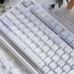 Confession Keycaps Set: Romantic pastel PBT dye-sublimated set, artfully displayed from various angles, emphasizing soft hues and gentle minimalist design.