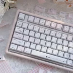 Multiple perspectives of the Crush PBT keycaps set, showcasing its durable PBT elegance, soft ethereal colors, and subtle romantic motifs that whisper.