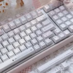 Crush PBT Keycaps Set, shown from a fresh angle. Its soft, ethereal colors and romantic motifs embody durable PBT elegance, whispering sophistication.