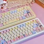 Whimsical Baby Zoraa Cute PBT Keycaps Set, shown from multiple angles. Highlights durable PBT, enchanting cartoon dolls, and a dreamy pastel angles.