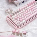 An enchanting angle of the cute pink PBT dye-sublimation keycap set, revealing its dreamy pastel aesthetic and whimsical motifs for a serene desktop.