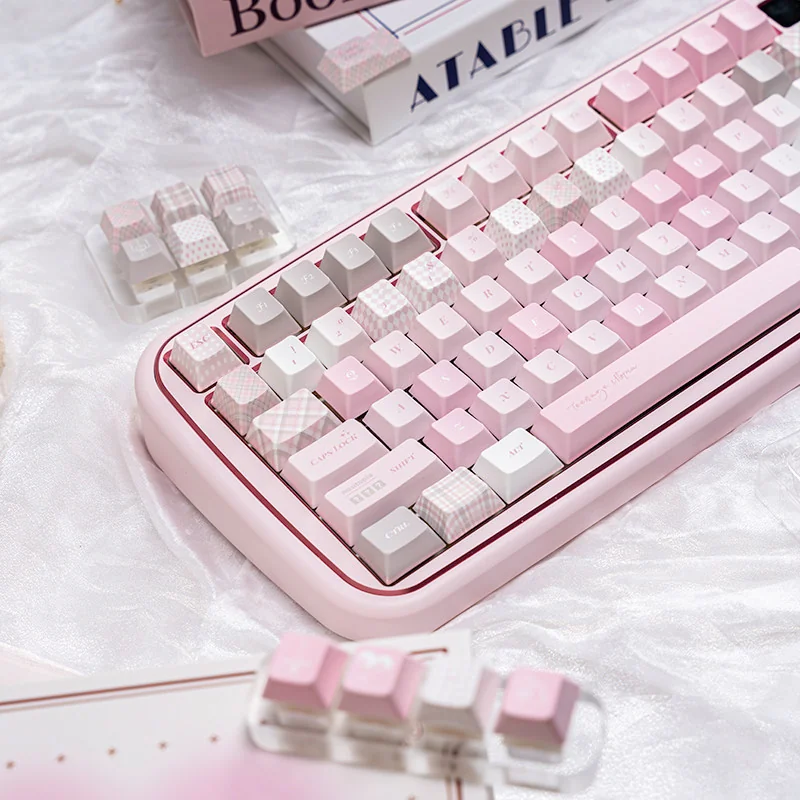 An enchanting angle of the cute pink PBT dye-sublimation keycap set, revealing its dreamy pastel aesthetic and whimsical motifs for a serene desktop.