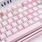 Close-up of the Dreamy Utopia cute pink PBT dye-sublimation keycap set, highlighting whimsical pastel motifs for a serene desktop setup.