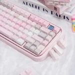 Close-up of a dreamy pink PBT dye-sublimation keycap set, showcasing cute pastel motifs for a whimsical desktop utopia. Perfect cute pink keycaps.