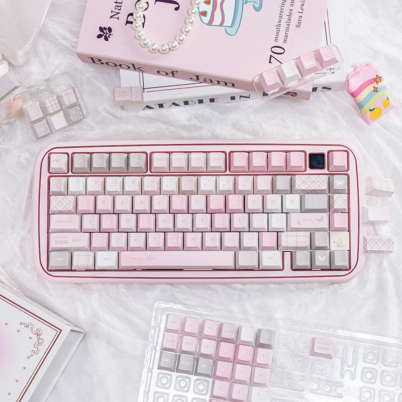 Dreamy pink PBT dye-sublimation keycap set, showcasing cute motifs for a serene desktop utopia. Perfect for a playful aesthetic.