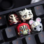 Close-up views of a vibrant, handcrafted Demon Slayer Muscle Mice artisan keycap from multiple angles, highlighting its intricate anime details.