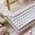 Charming Dessert Cat PBT Keycap Set, shown from a whimsical angle, revealing more adorable pastel cats enjoying their sweet treats.