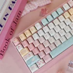 A delightful Sweet Treats Dessert Keycap Set in soft pastels and creamy hues, showcasing the delicious PBT dye-sub keycaps from multiple playful angle.