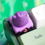 Playful Ditto rotating artisan keycap shown from multiple angles, highlighting its cute interactive Pokemon design and meticulous handcrafted resin design.