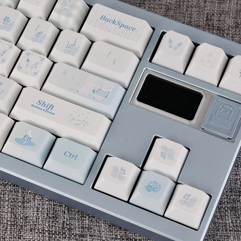 Dream Butterfly PBT dye-sub keycaps set. Ethereal blue-white butterfly motifs from various angles, highlighting durable mechanical PBT.