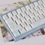 Artistic views of Dream Butterfly PBT dye-sub keycaps set, highlighting durable PBT and serene blue and white butterfly motifs for mechanical keyboards.