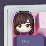 Vibrant handcrafted D.VA keycap, an Overwatch artisan accessory featuring detailed resin art and iconic pink hues, perfect for gamers.