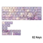 A collection of elegant violet side-engraved PBT keycaps set displayed from various angles, highlighting their clean tops and discreet legends for a premium setup.