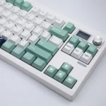 Durable PBT Dye-Sub emblem keycap set, featuring classic heraldic symbols. Elegant, subdued colors for keyboards, highlighted from a unique angle.