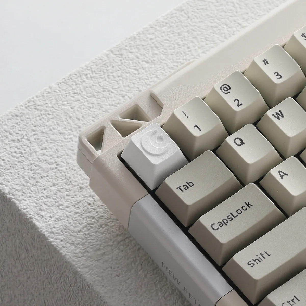 Close-up of a precision CNC moon ESC keycap, showcasing its sleek metallic finish and minimalist celestial design from multiple angles.