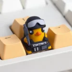 A playful, handcrafted resin Escape from Duckov: Duck Keycaps, showcasing its whimsical 3D duck character in tactical gear from a unique side angle.