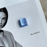 Close-up of an ethereal butterfly keycap, showcasing its intricate handcrafted aluminum alloy details and artistic metallic finish on an ESC key.