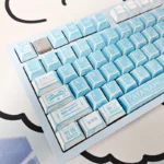 Artistic close-up of Evangelion Unit-00 PBT keycaps set from a top-down angle, showcasing the vibrant manga graffiti and bold anime aesthetic.