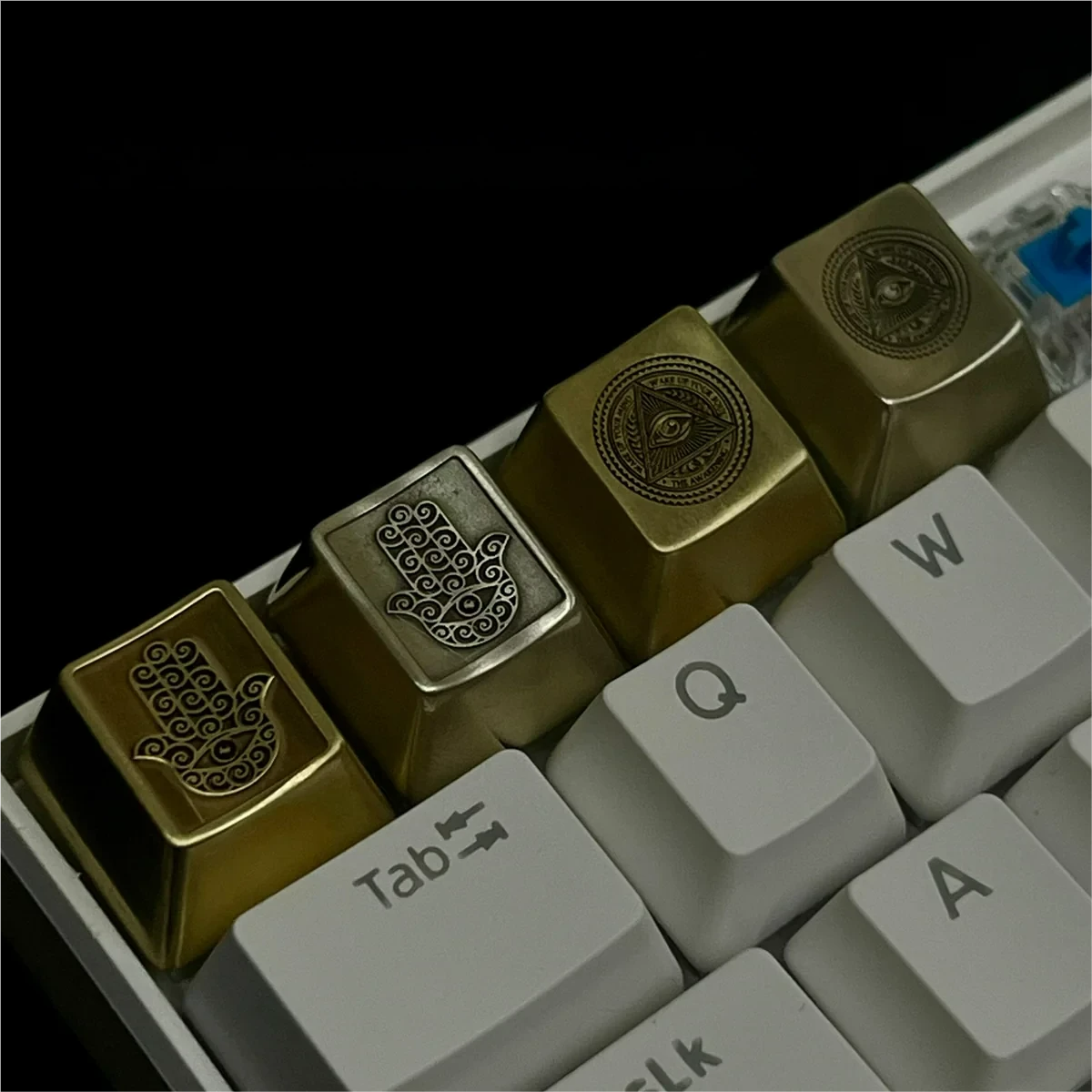 Close-up views of the Mystical Eye of Horus Keycaps, showcasing its intricate mystical eye motif and symbolic metalwork from various angles.