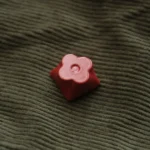 Floral Keycap: precision CNC aluminum, captivating etched floral design from multiple angles. Highlighting artisan elegance, tactile art.