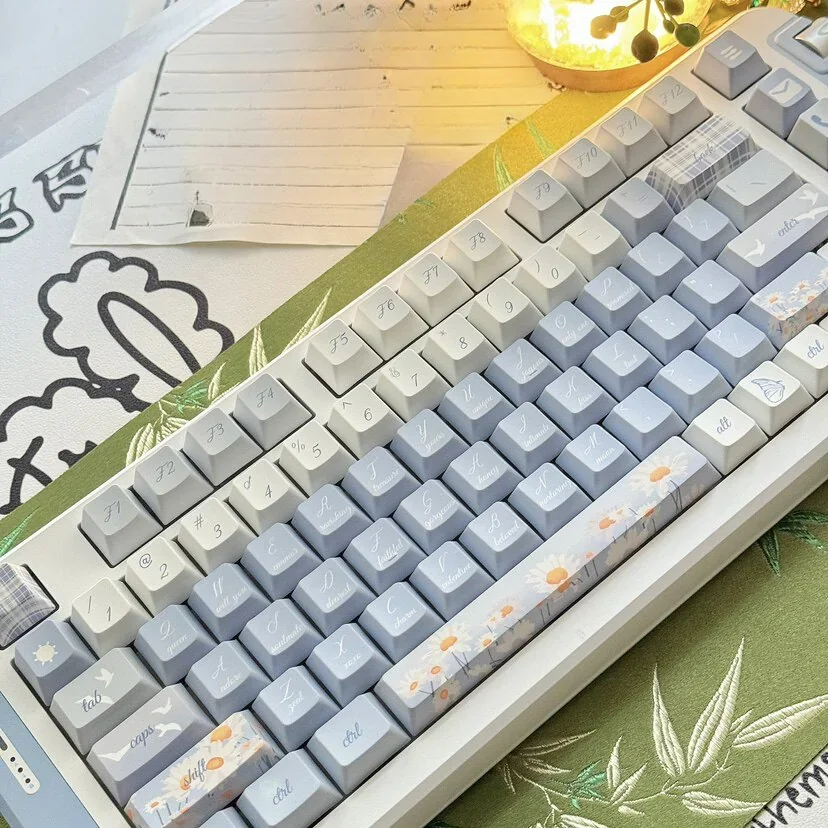 A collection of durable Midsummer Daisy Cherry Keycap Set featuring delicate daisy designs, showcasing various angles for a serene desktop aesthetic.