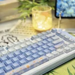 A detailed view of the durable PBT dye-sub Midsummer Daisy Cherry Keycap Set, highlighting the delicate chrysanthemum design and serene summer aesthetic from an artistic angles.
