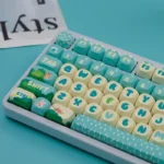 Gallery of the Enchanted Forest PBT MOA Artisan Keycap Set, revealing its whimsical, vibrant forest landscape and durable PBT material from multiple artistic angles.