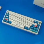 Exclusive Gawr Gura PBT Dye-Sub Keycaps set. Vibrant blue, white, and red shark-girl design shown from multiple angles for custom mechanical keyboard.