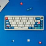 Exclusive Gawr Gura PBT Dye-Sub Keycaps Set in vibrant blue, white, red. Views show her iconic shark-girl aesthetic, premium and playful.