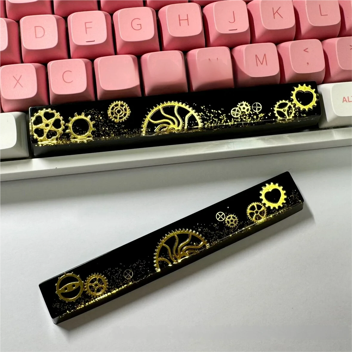 Artisan Resin Gear Space Key Keycap, a detailed view of intricate industrial gears encased in dark, polished resin. Highlights handmade quality and solid design.