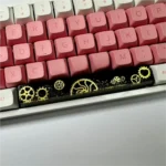 Angled view of the artisan resin gear Space Key keycap, detailing intricate industrial gears in dark, polished resin, emphasizing its solid.