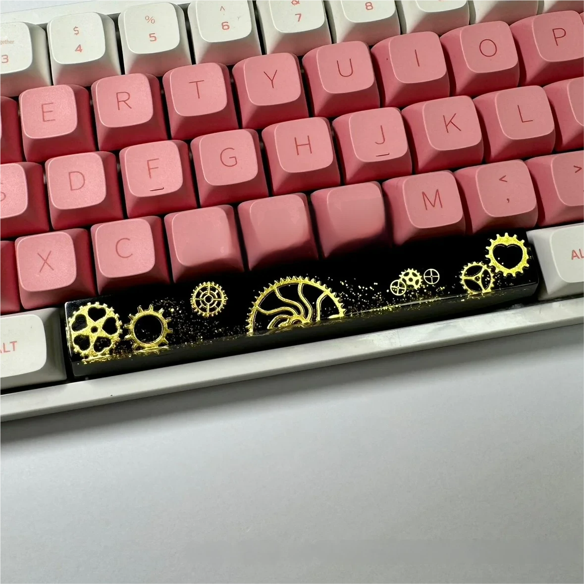 Angled view of the artisan resin gear Space Key keycap, detailing intricate industrial gears in dark, polished resin, emphasizing its solid.