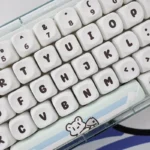 Unique Glacier Bear PBT Dye-sub MOA keycaps Set. Icy blue and white tones, adorable bear motif, serene winter landscape, showcasing premium art.