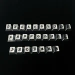 Close-up of handcrafted Gothic alphabet keycaps set, showcasing intricate medieval-inspired artistry and a dark, mystical aesthetic from the Timeless design.